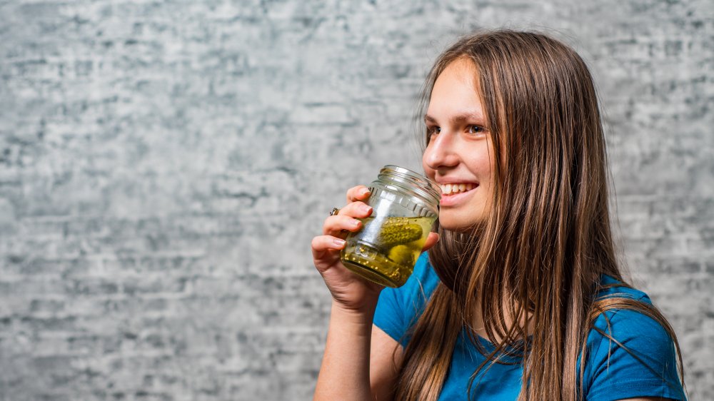 Girl drinking pickle juice