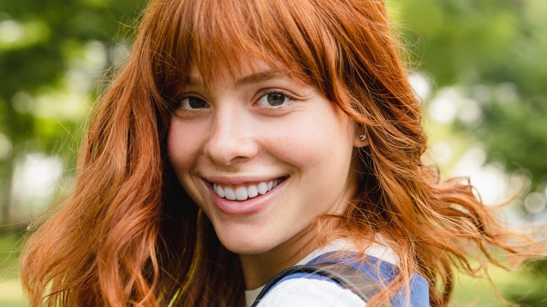 woman with red hair smiling