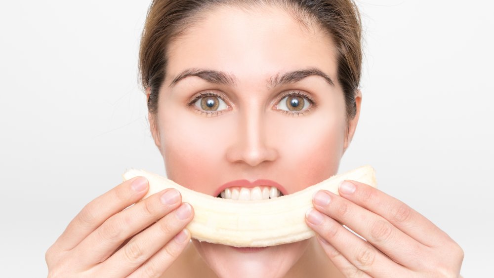 Woman eating banana 