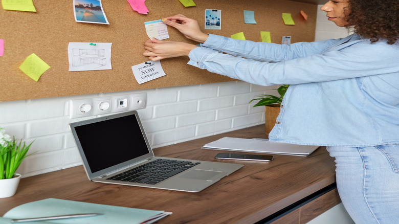 Woman placing notes on a board