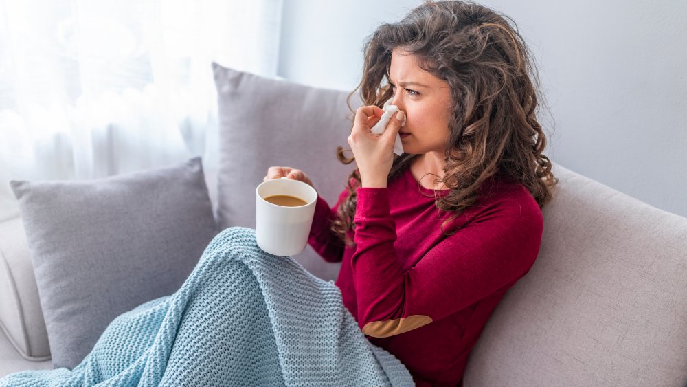 Woman with cold drinking tea