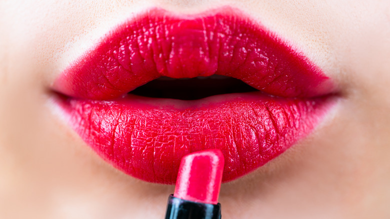 Woman wearing a reddish pink lipstick