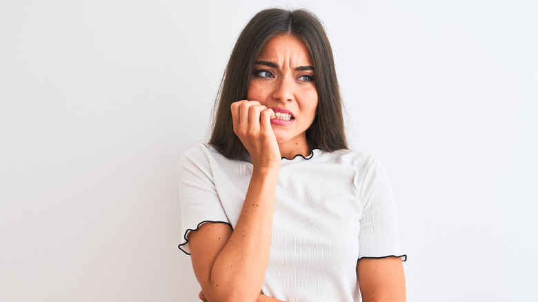 Woman biting her nails 