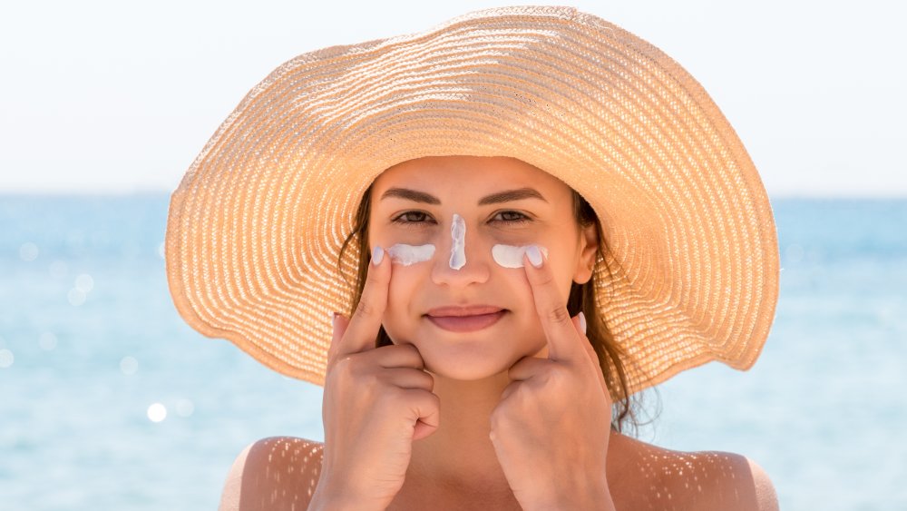 Woman tanning with sunblock