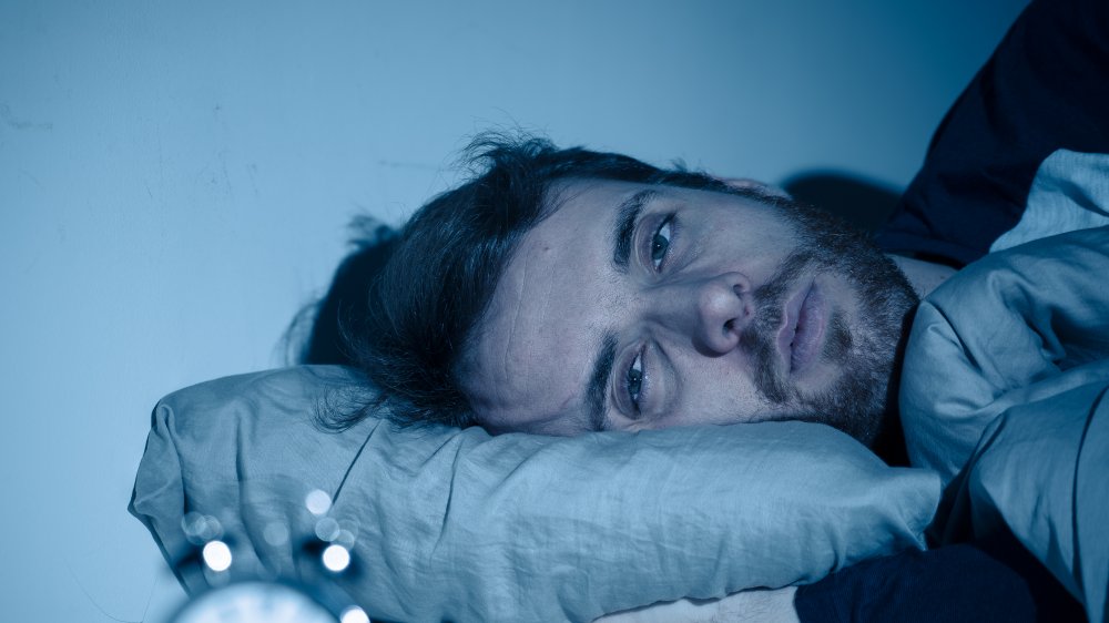 Sleepless man in bed