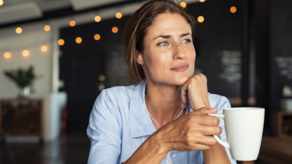 Woman drinking coffee (or tea)