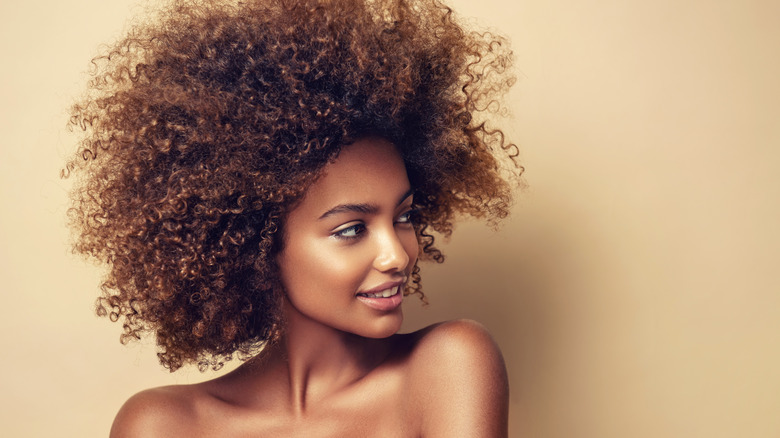 Beautiful natural hair on woman looking to the side