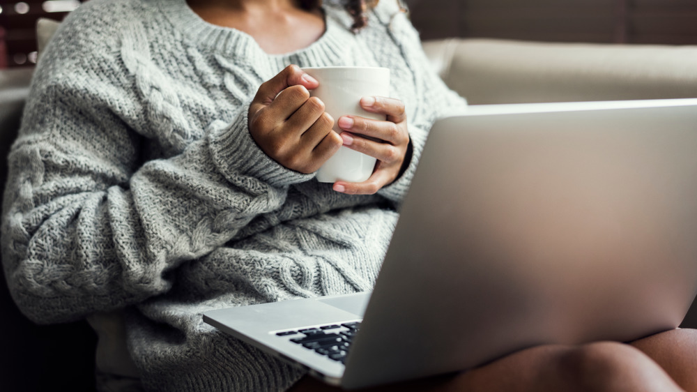 A woman with a laptop on her lap