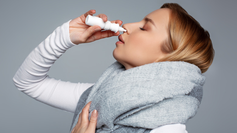 Woman using nasal spray