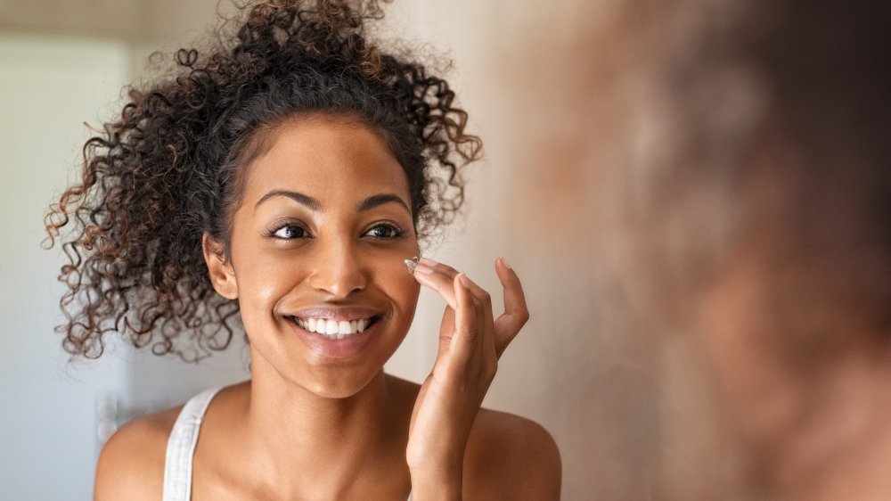 Woman applying skincare