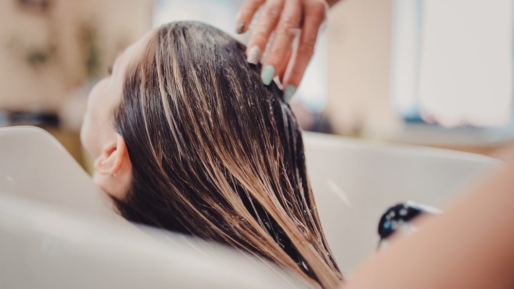 Having hair washed at a salon