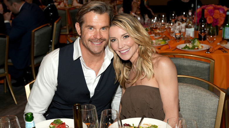Katie Cassidy and Stephen Huszar seated at a table.