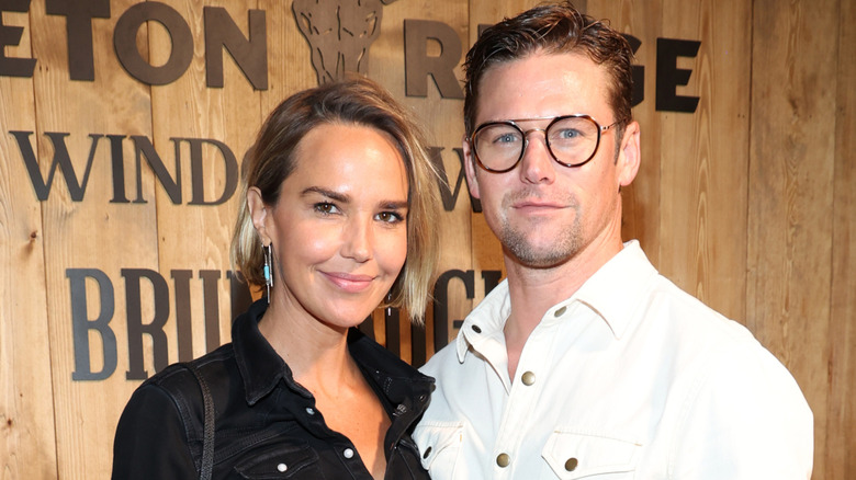 Arielle Kebbel and Zach Roering pose together at an event.