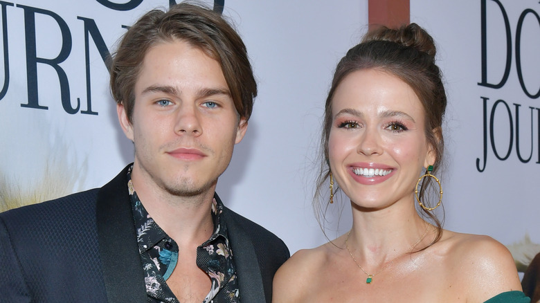 Jake Manley and Jocelyn Hudon pose together at an event.