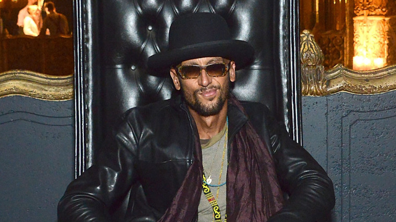 Santino Rice posing at an event in 2014 with a black fedora and black leather jacket.