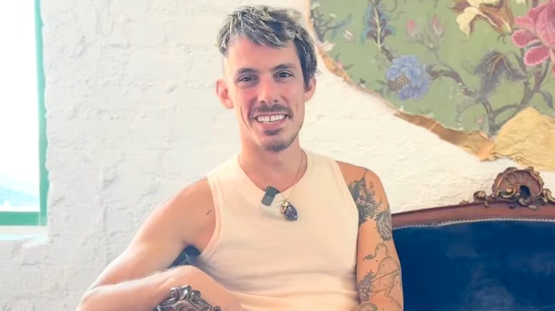 Timothy Westbrook smiling and wearing a white sleeveless tank top in 2025
