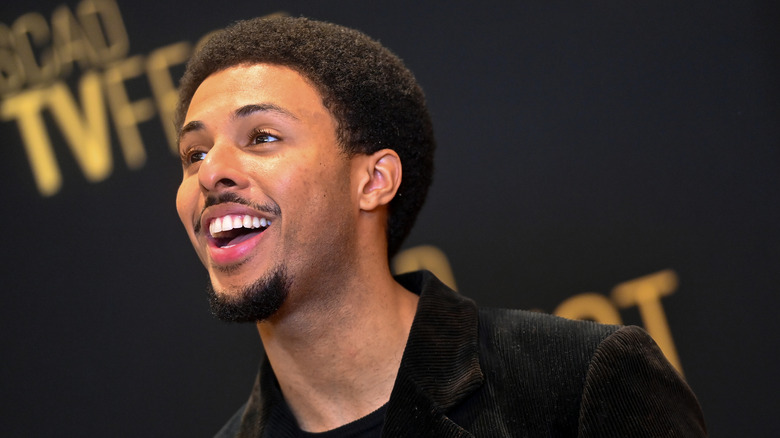 Diggy Simmons smiling on at a Grown-ish press junket