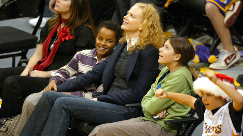 Nicole Kidman looking up while sitting courtside at a basketball game with children Connor and Isabella.