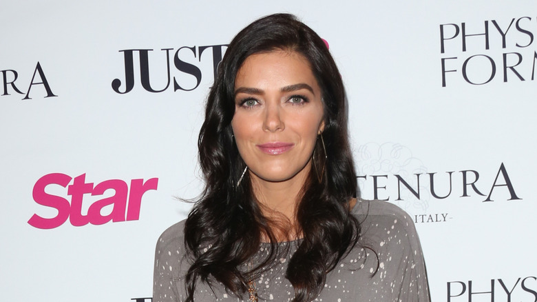 Adrianne Curry smiling for photo in April 2016