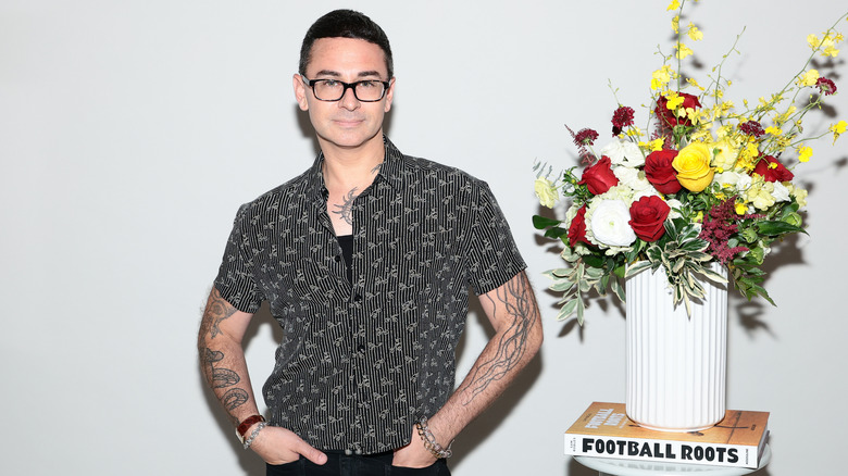 Christian Siriano (posing next to flowers) at a FIFA World Cup celebration in 2026.