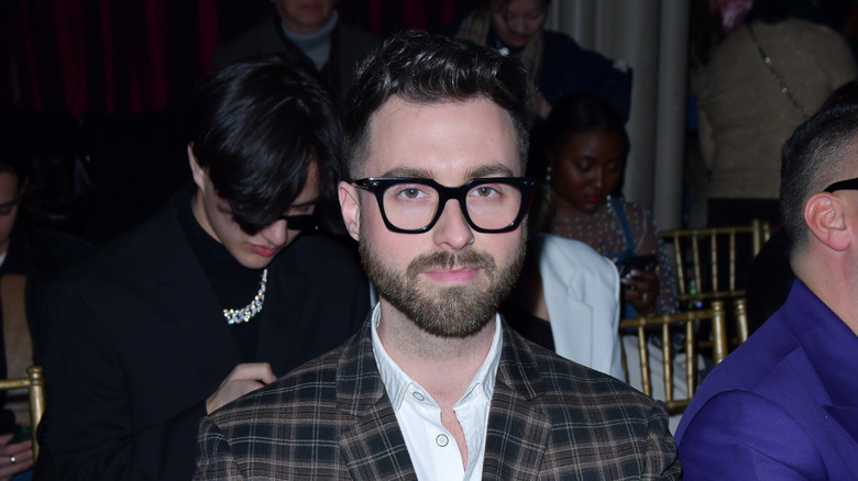 Gunnar Deatherage slightly smiling at 2024 New York Fashion Week.