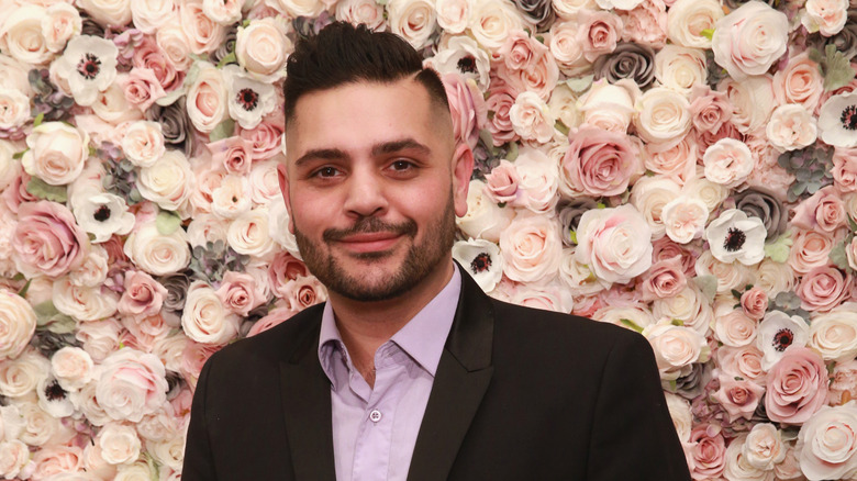 Michael Costello smiling at New York Fashion Week in 2017.