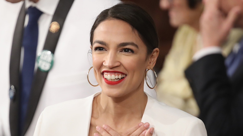 Alexandria Ocasio-Cortez wearing gold hoop earrings