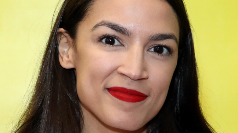 Alexandria Ocasio-Cortez poses at an event