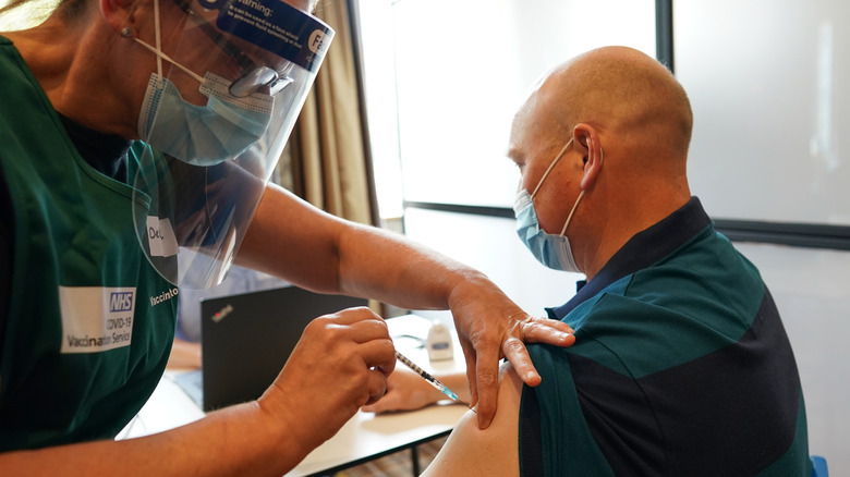 Man receiving COVID-19 vaccine