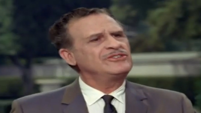 Frank Wilcox plays Mr. Brewster in "The Beverly Hillbillies" standing outside in a suit