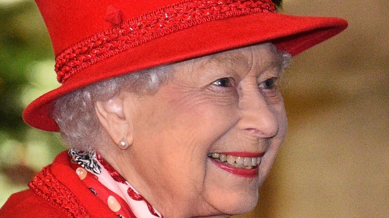 Queen Elizabeth II in red hat