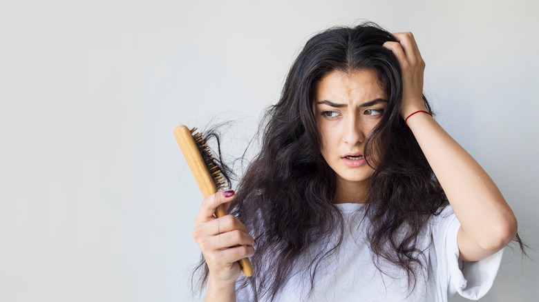 woman brushing tangled hair