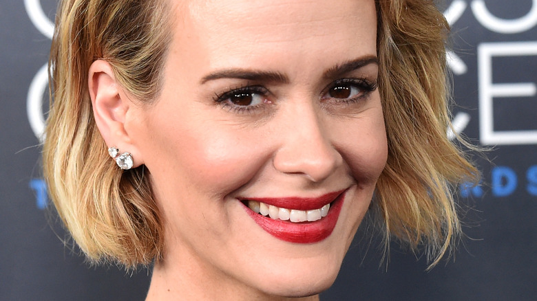 Sarah Paulson smiling with red lipstick