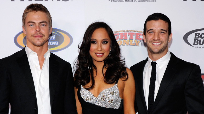 Derek Hough, Cheryl Burke, and Mark Ballas at an event.