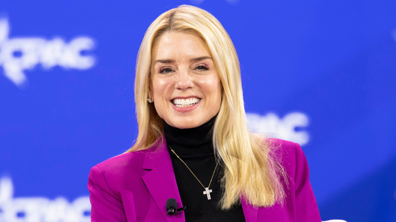 Pam Bondi at CPAC fuchsia jacket and cross