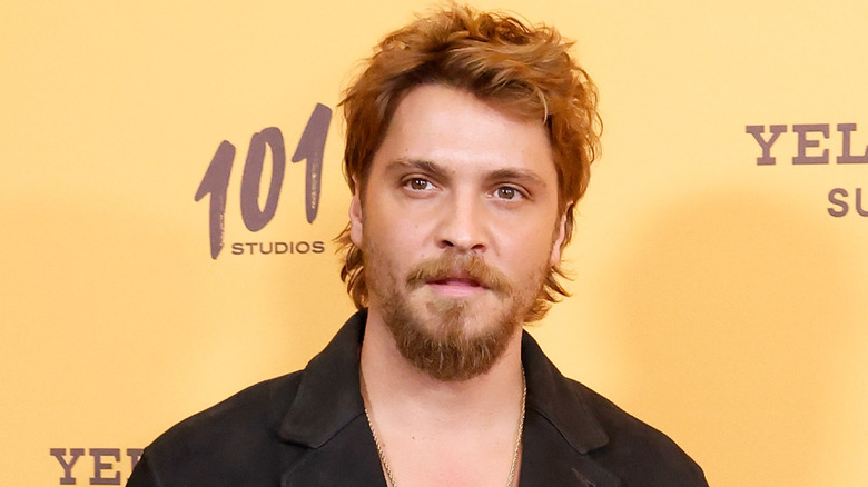 Luke Grimes posing at a Yellowstone event