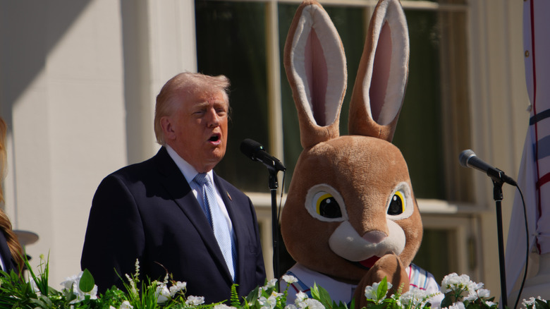 Donald Trump on the White House balcony with someone dressed like the Easter Bunny.