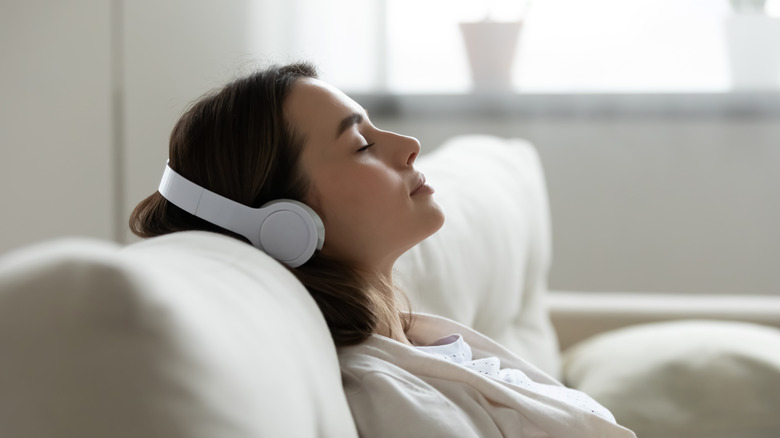 A woman resting with headphones on 