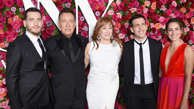 Bruce Springsteen posing with his family 