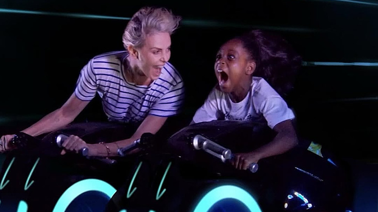 Charlize Theron riding the TRON Lightcycle with her daughter at Disney World in 2024