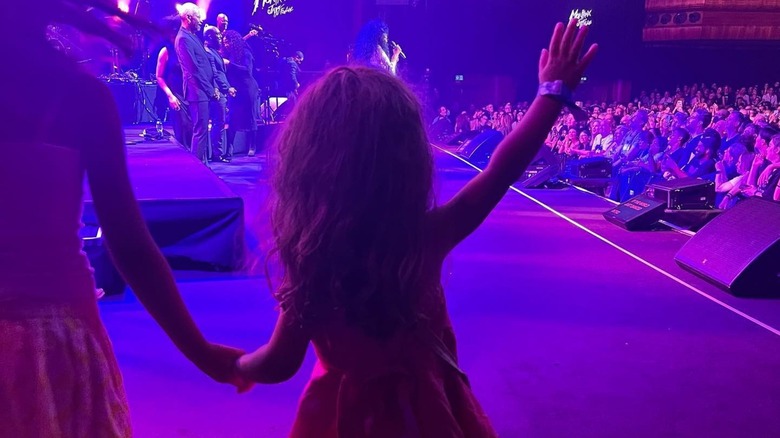 The back of Everlee Ross-Faulkner as she walks out onstage with her grandmother
