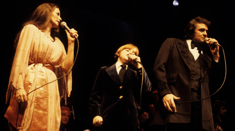 June Carter Cash, John Carter Cash, and Johnny Cash performing together
