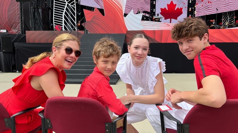 Sophie Gregoire smiles sitting with her three kids Ella, Xavier, and Hadrienon Canada Day dressed in red and white