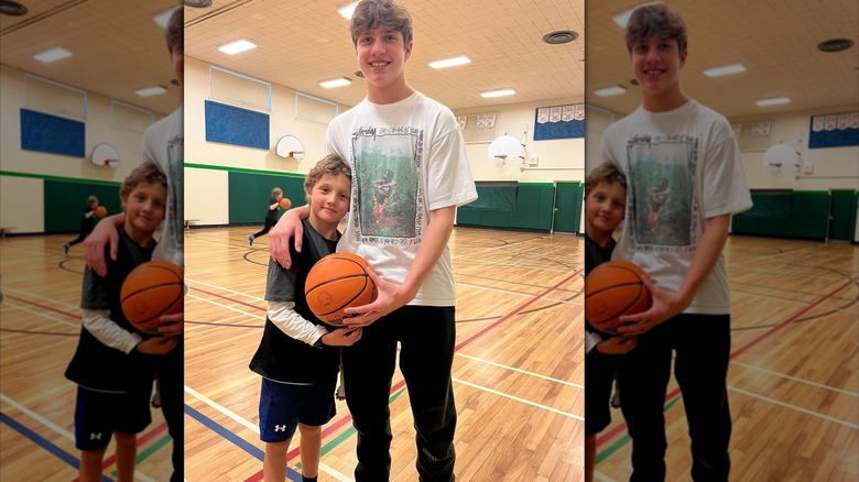 Xavier and Hadrien Trudeau pose together smiling on a basketball court