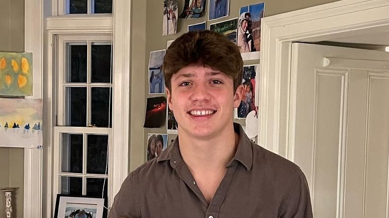 Xavier Trudeau smiles as a teenager in a brown shirt