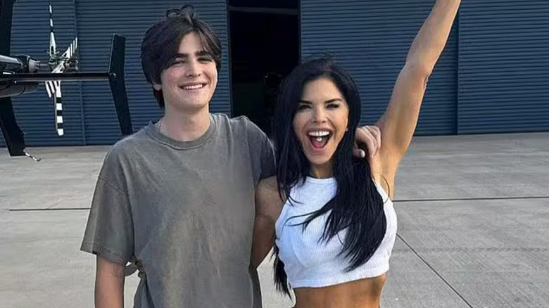 Evan Whitesell arm around Lauren Sánchez who has one arm raised