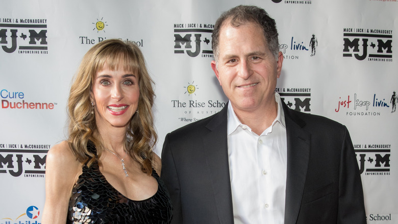 Susan Dell and Michael Dell smiling while posing for photos together at an event