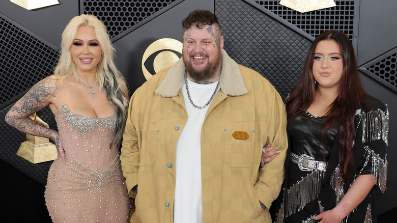 Bunnie XO, Jelly Roll, and Bailee Ann smiling on the Grammys red carpet