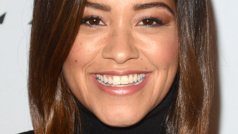 Gina Rodriguez smiles for a photograph. 