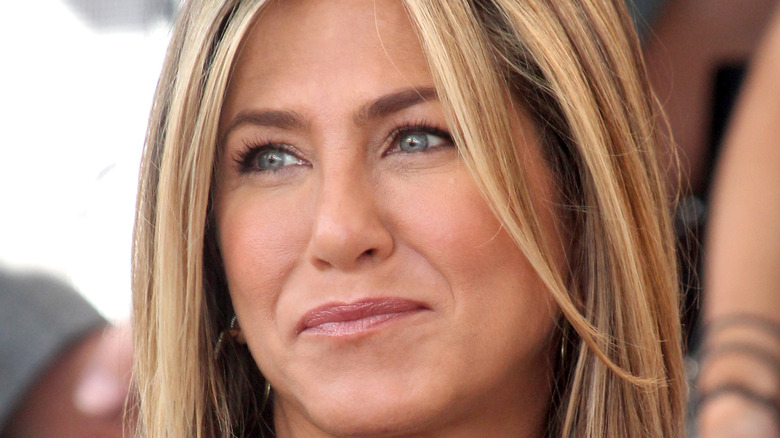 Jennifer Aniston smiling at an event. 